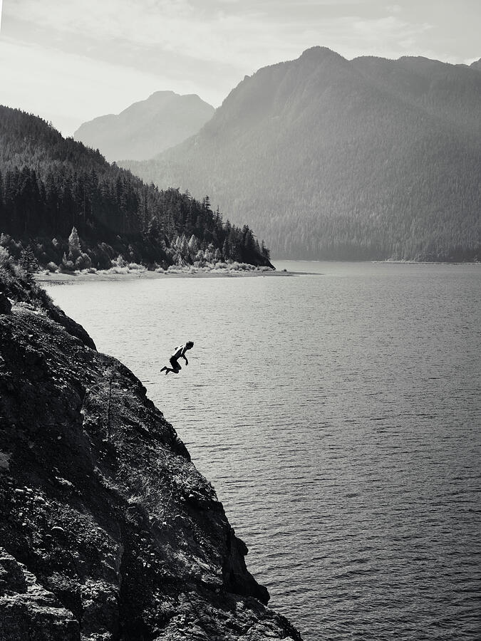 Cliff jumper above Buttle Lake in Strathcona Provincial Park Vancouver Island