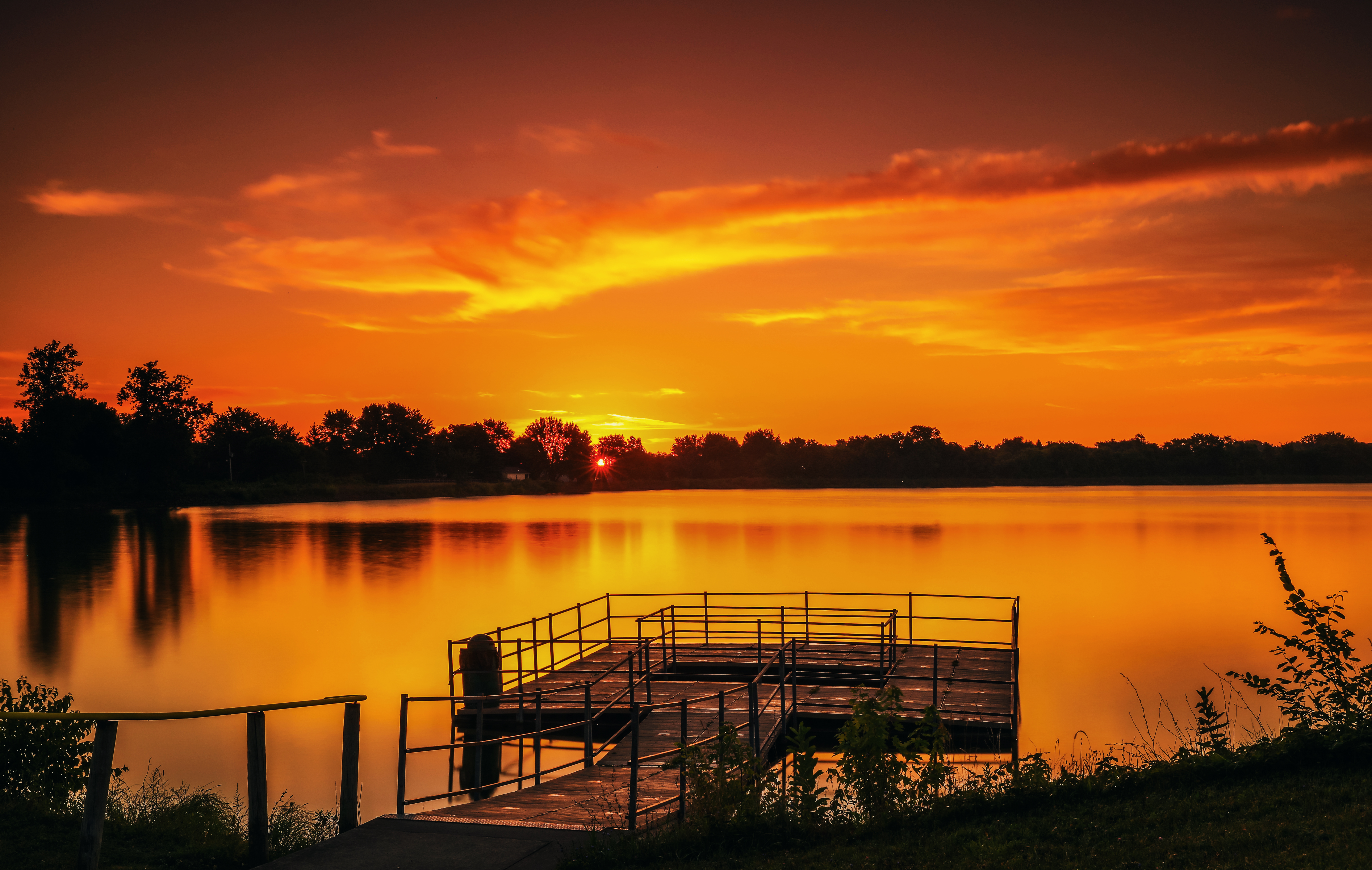 Vivid sunrise over a Lima Ohio lake by Dan Sproul