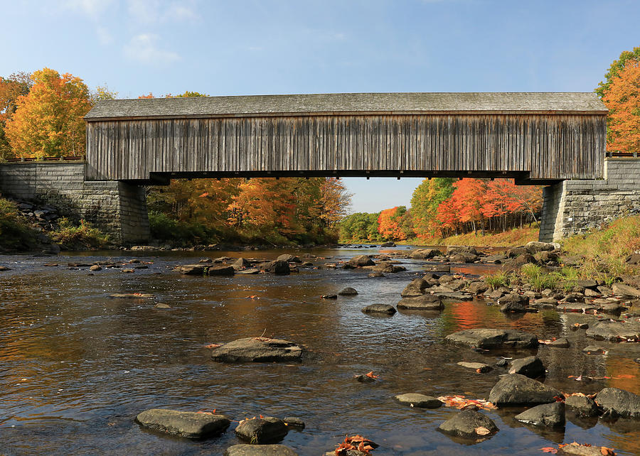 Lowes Covered Bridge over a river in Maine fall color