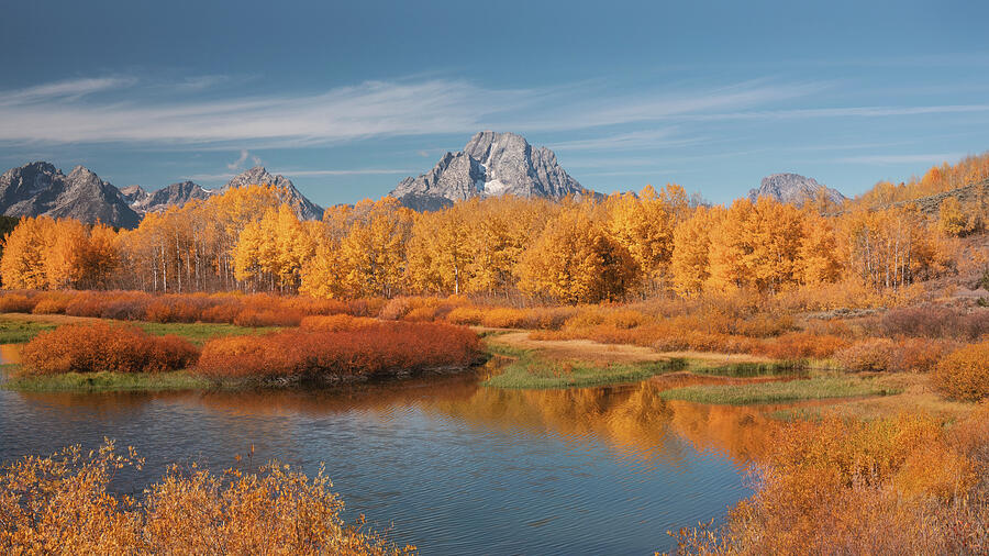 Mount Moran rising above golden autumn wetlands in Grand Teton National Park photographed by Dan Sproul